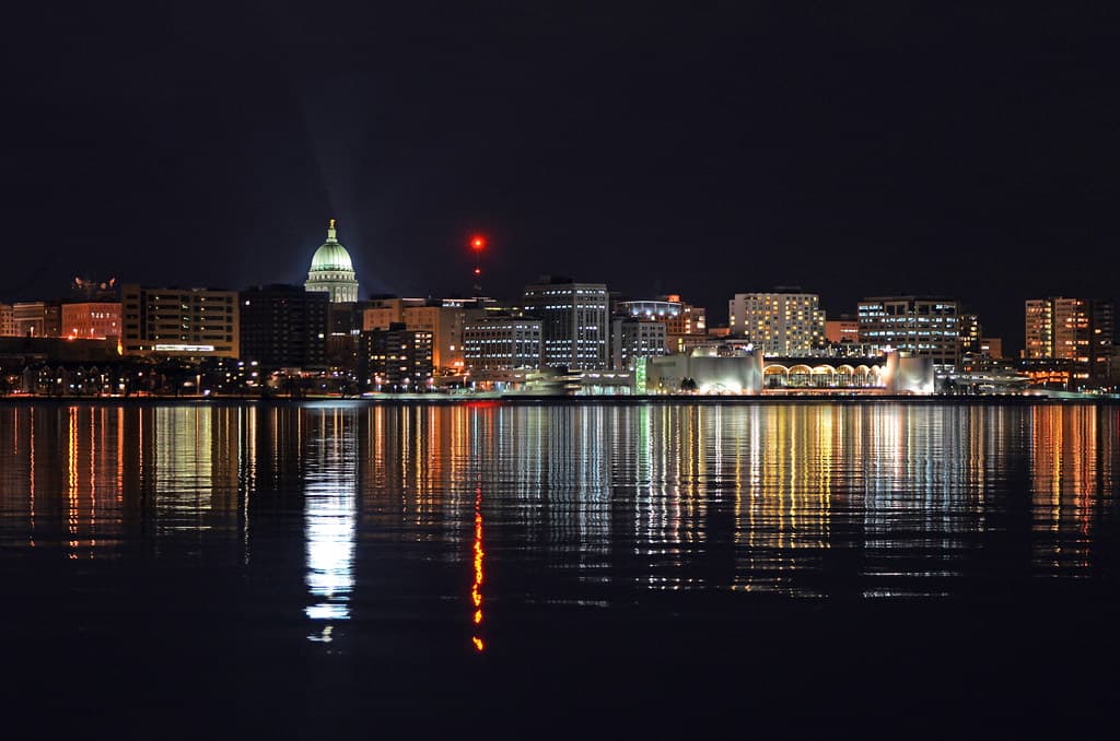 Loan portfolio options for Wisconsin home buyers featuring Madison skyline at night - MadCity Home Loans